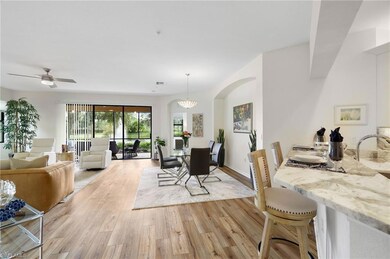Dining area with light wood-style floors and arched walkways