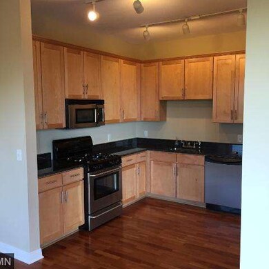 This open kitchen features Granite counters, Maple