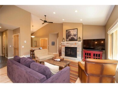vaulted ceiling and fireplace open to the kitchen