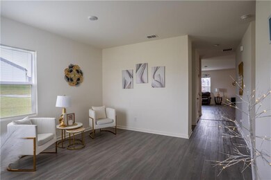 Sitting room with dark wood finished floors and baseboards