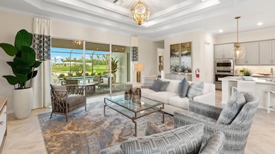 A comfortable gathering space for hosting movie nights or holiday parties, this living room flows ou