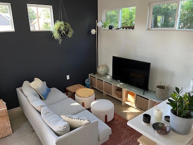 Living area with plenty of natural light and conc