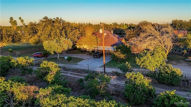 View from above of property featuring a tree filled landscape