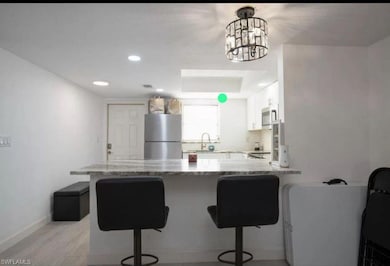 Kitchen with stainless steel appliances, a breakfa