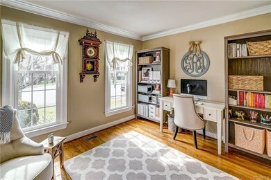 Bright and airy office with hardwood floors, crown