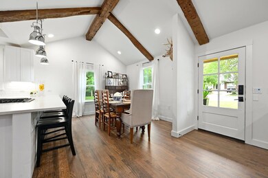 Dining space featuring dark wood-type flooring, r
