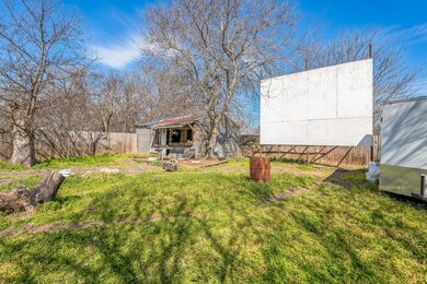View of yard featuring an outbuilding and fence