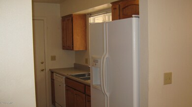 Kitchen view of fridge and dishwasher