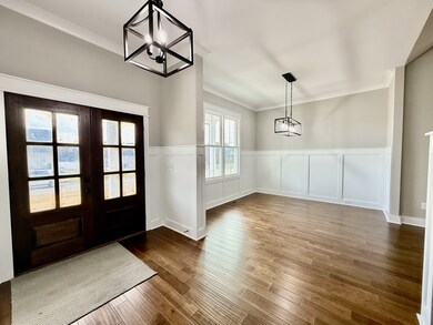Large dining area with beautiful detailed farm house style trim and hardwood flooring