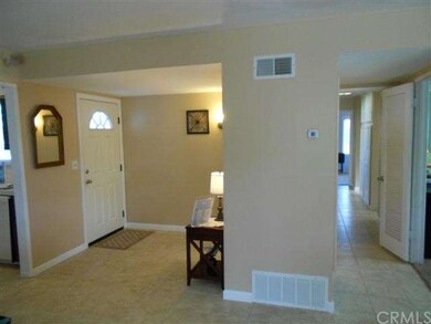 Another view of the entry with paneled coat closet