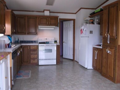 another view of the kitchen with the utility conveniently located beside the kitchen