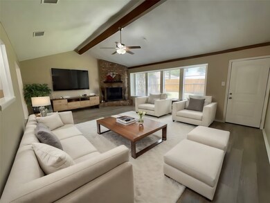 Spacious living room. Neutral tones with a brick f