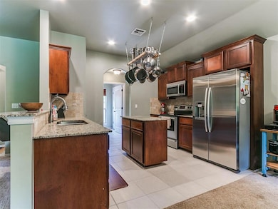 Kitchen with appliances with stainless steel finis