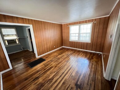 Spare room featuring ornamental molding, cooling u
