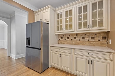 Right side of kitchen featuring custom cream cabin