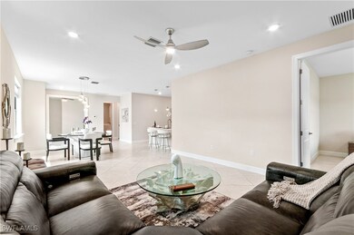 Living area featuring ceiling fan, light tile patt
