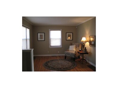 Living Room With Warm Neutral Wall Color and Hardw