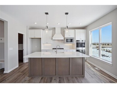 The stunning gourmet kitchen features a double wal