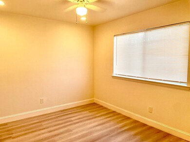 Empty room with wood finished floors and ceiling fan