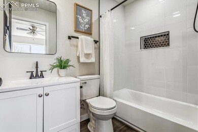 Full bathroom with ceiling fan, toilet, vanity, ha