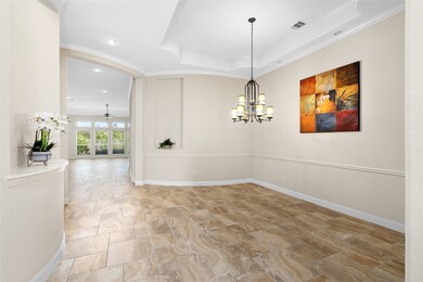 Your new bright, sizeable dining room features high ceilings, elegant lighting, and tile flooring. The open floor plan allows ample natural light from the large windows.