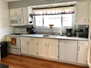 The kitchen is stocked with loads of cabinetry and