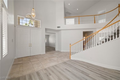 Entrance foyer with baseboards, visible vents, a n