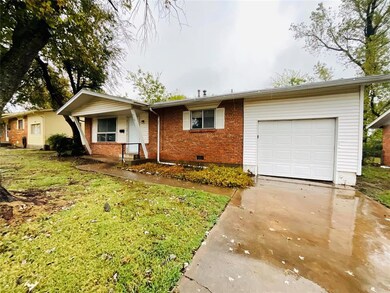 Ranch-style house with a front lawn and a garage