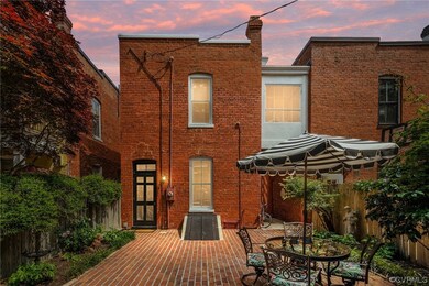 back patio with gated passage to front of home