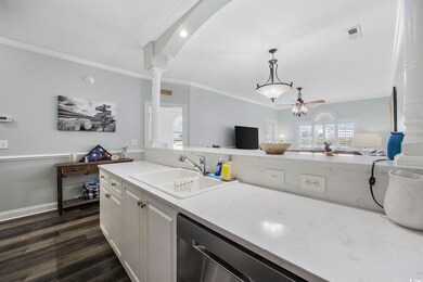 Kitchen with ceiling fan, ornamental molding, sink