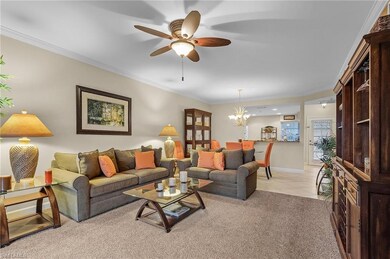 Carpeted living room featuring ceiling fan with no