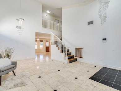 Stairway featuring a towering ceiling, ornamental
