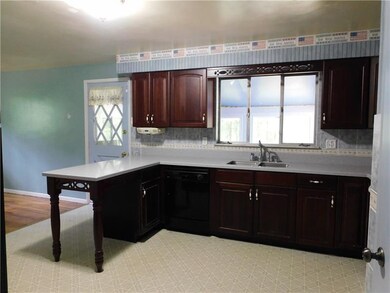 Spacious kitchen with dark stain cabinets.