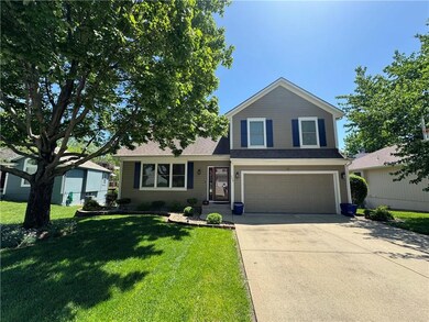 View of front of house with a garage and a front yard