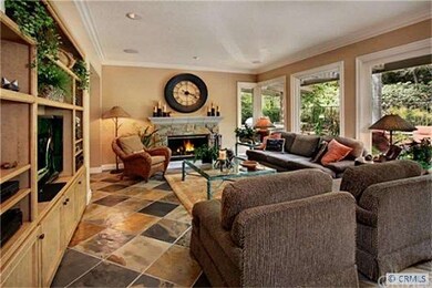 Family room has one of  three cozy fireplaces in t