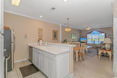 Kitchen with light tile flooring, ceiling fan with