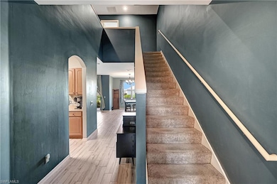 Stairs with hardwood / wood-style floors, a notabl