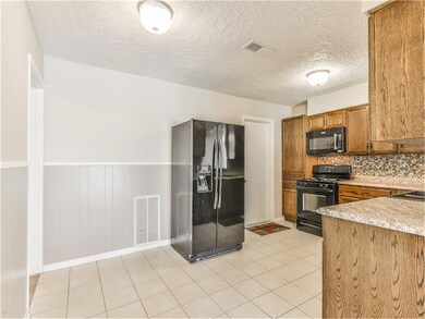 Spacious and functional, the kitchen has plenty of room for seating or additional storage.