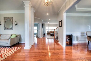 The foyer, with a fabulous new chandelier, greets 