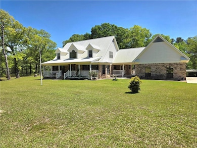 Farmhouse inspired home featuring a porch, metal r
