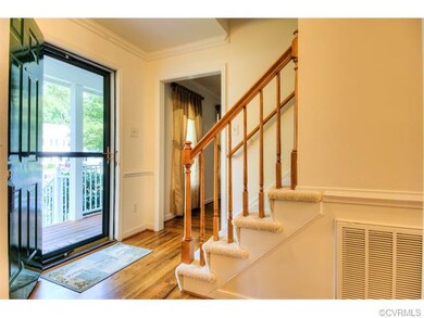 The foyer features hardwood floors and crown mould