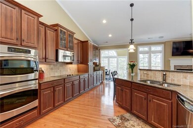Large open kitchen with double wall oven, lights a