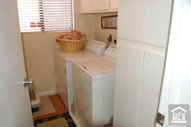 Inside laundry area with overhead linen cabinets.