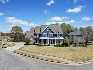 View of front of home featuring driveway, stone si