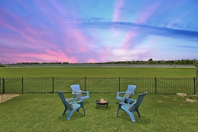 Yard at dusk with a fire pit and a view of countr