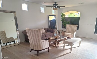 Living room featuring baseboards, visible vents, l