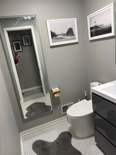 Half bath featuring vanity and toilet