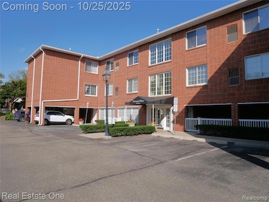 View of apartment building / complex with uncovered parking