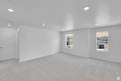 Unfurnished room featuring light colored carpet and recessed lighting