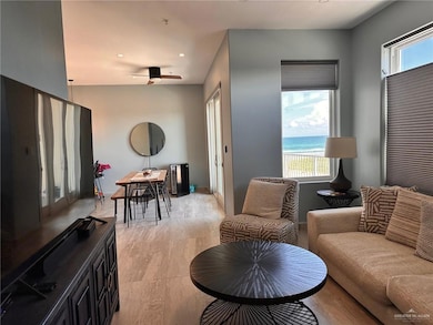 Living area featuring a water view, recessed lighting, and ceiling fan